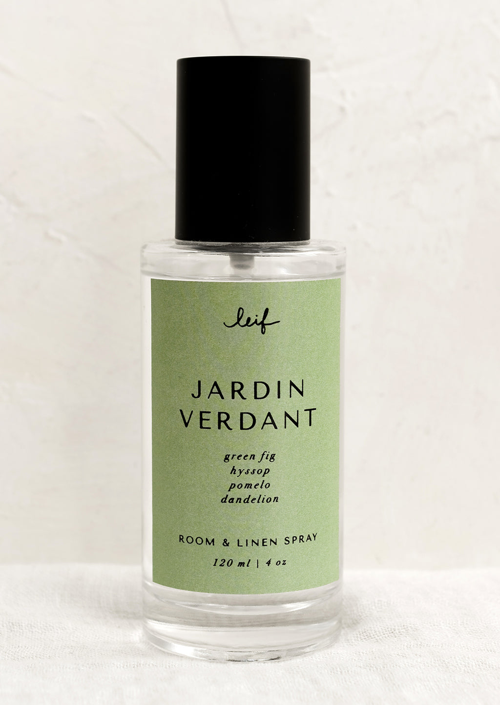 Jardin Verdant: A room spray bottle with printed text on green label.