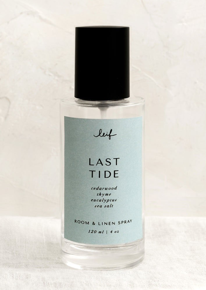 Last Tide: A room spray bottle with printed text on blue label.