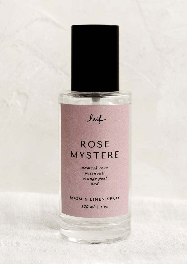 Rose Mystere: A room spray bottle with printed text on pink label.