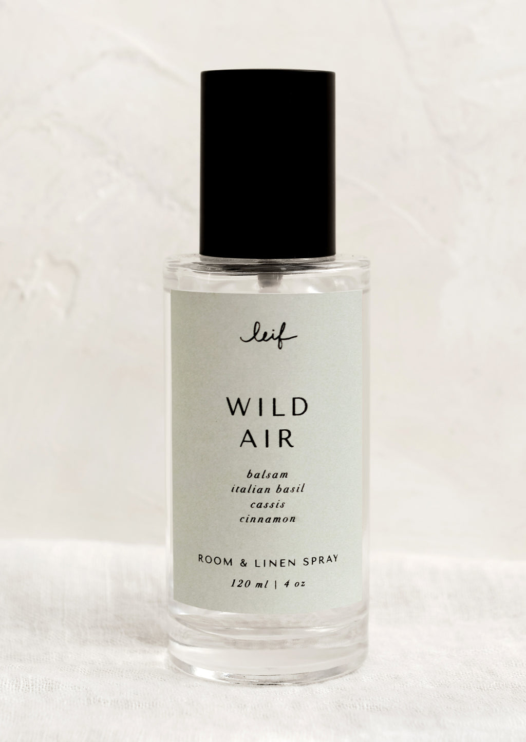 Wild Air: A room spray bottle with printed text on seafoam label.