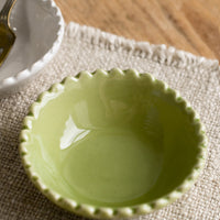 1: A small ceramic bowl with scalloped rim in green.