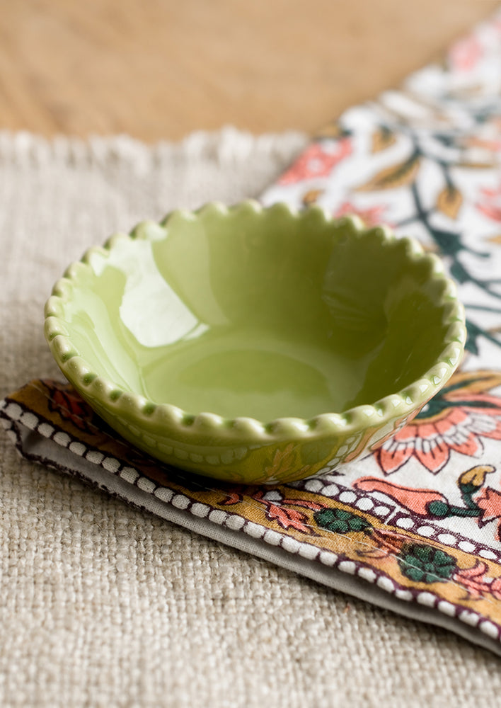 Meadow Green: A small ceramic bowl with scalloped rim in green.