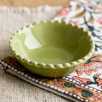 Meadow Green: A small ceramic bowl with scalloped rim in green.