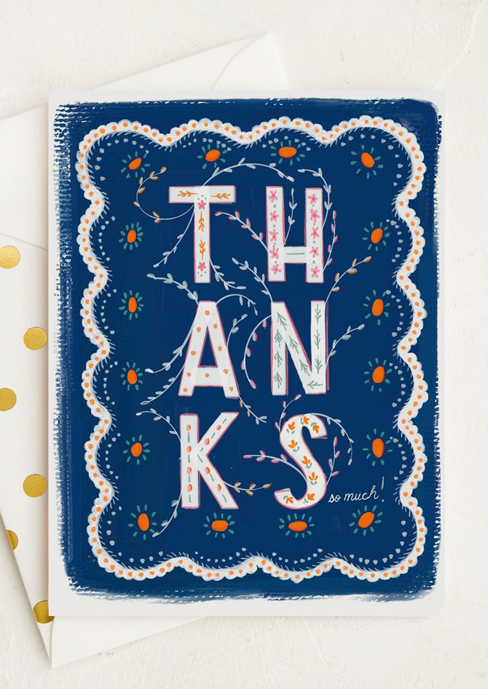 1: A navy doily-shaped thank you card.