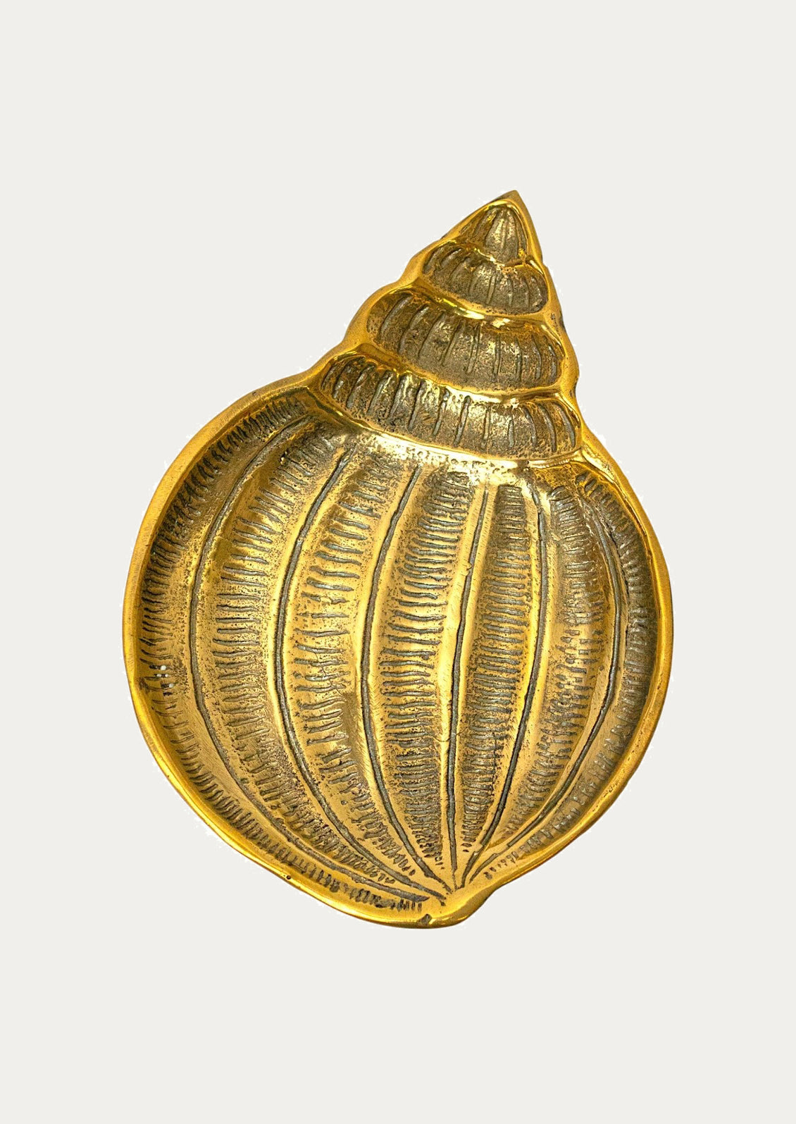 A shell-shaped shallow catchall dish in solid brass.
