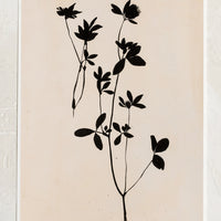1: An art print of black silhouetted flower on beige background.