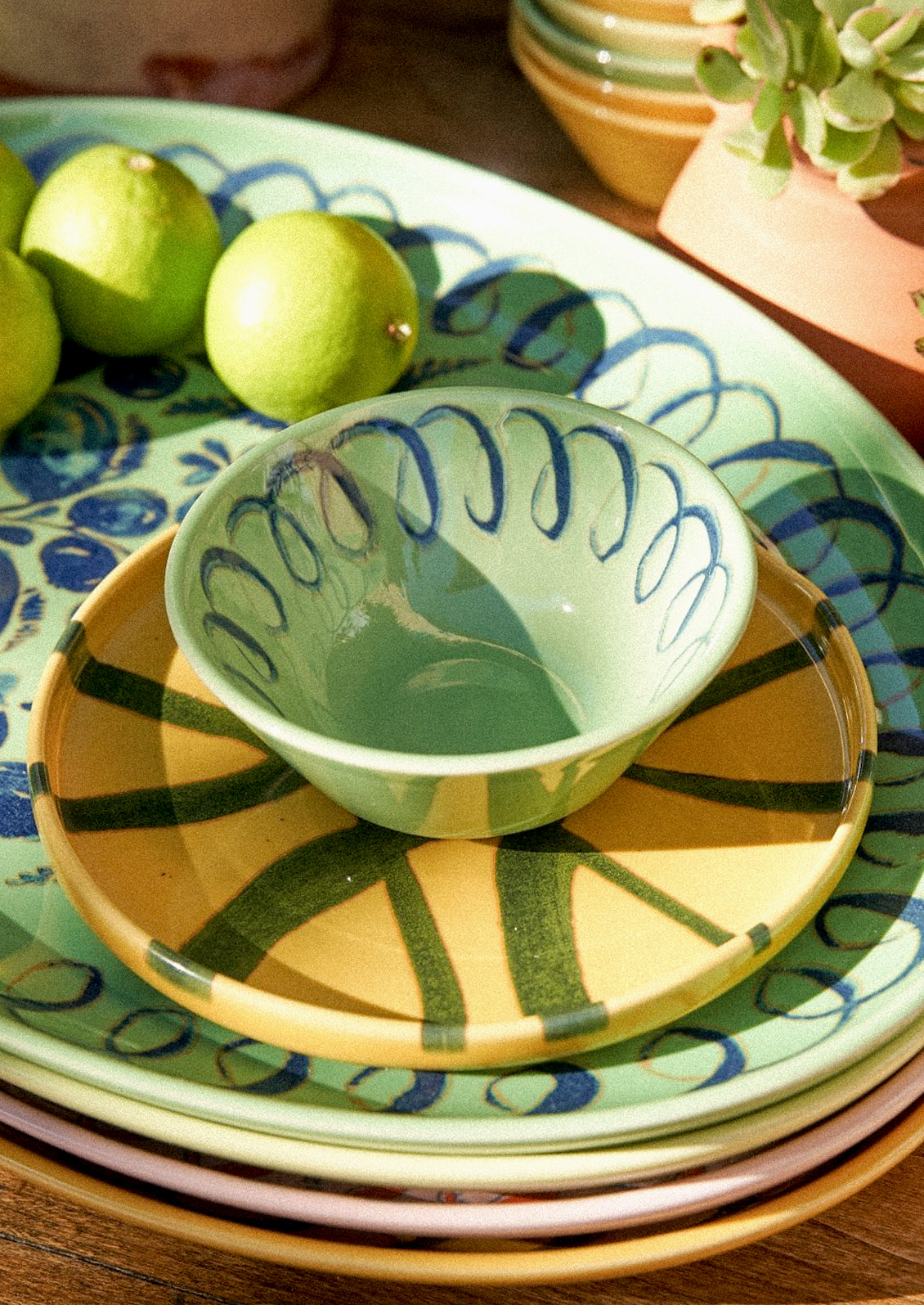 A green bowl with a squiggle design along the edge.