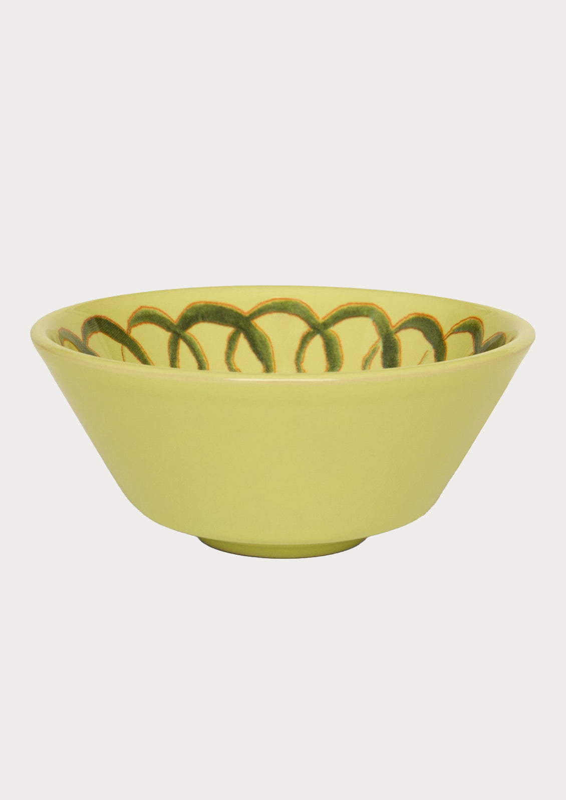 A greenish yellow bowl with a squiggle design along the edge.