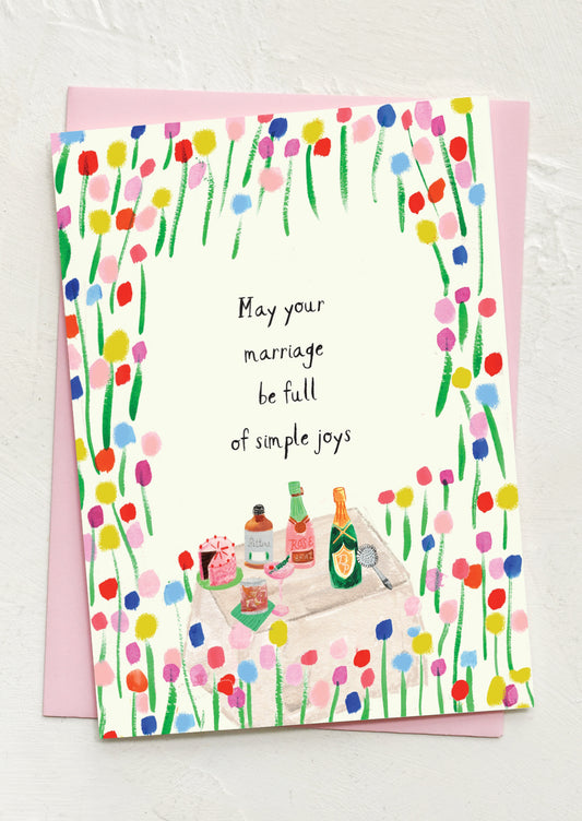 Greeting card with colorful floral design and couple at picnic, text 'May your marriage be full of simple joys'.