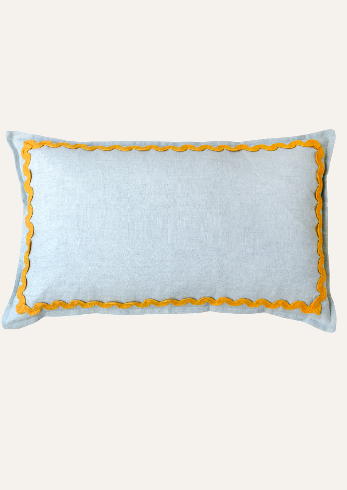 A rectangular linen pillow in a sky blue color with a yellow squiggle border attached along the edges.