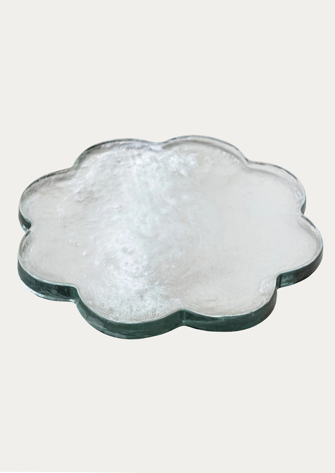 Flower-shaped glass tray with a textured surface.