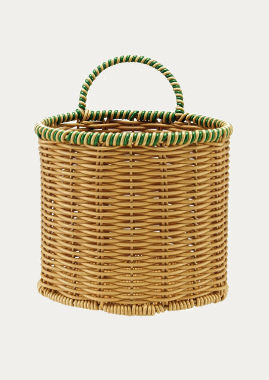 Wicker basket with green handle on a white background