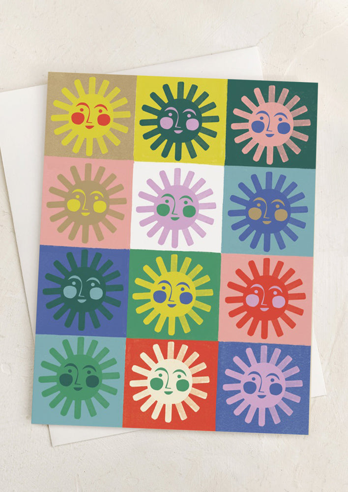 1: A multicolor checker print card with smiling suns in each square.
