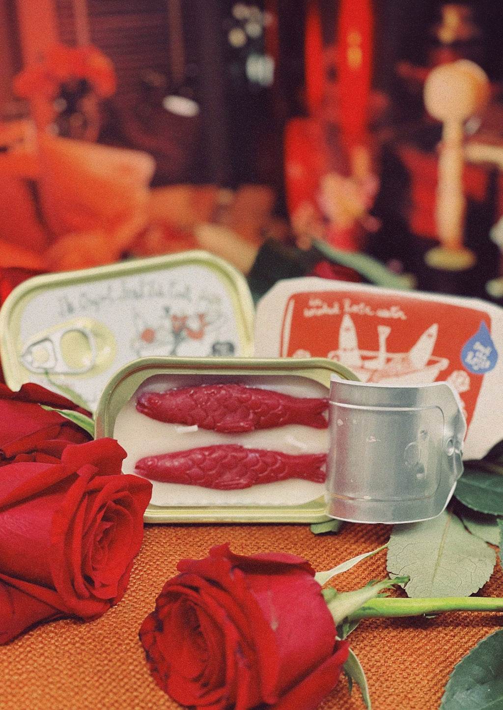 Smoked Rose Water: A tinned fish candle with red fish in rose water scent.