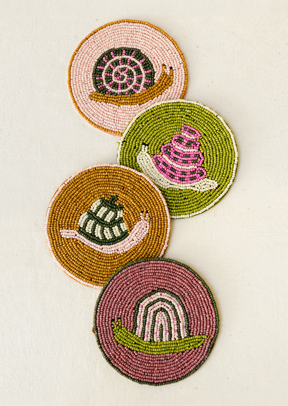 A set of 4 beaded coasters with a different snail design on each.