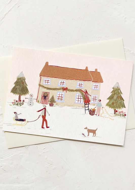 A greeting card with illustration of people decorating a house for the holidays.