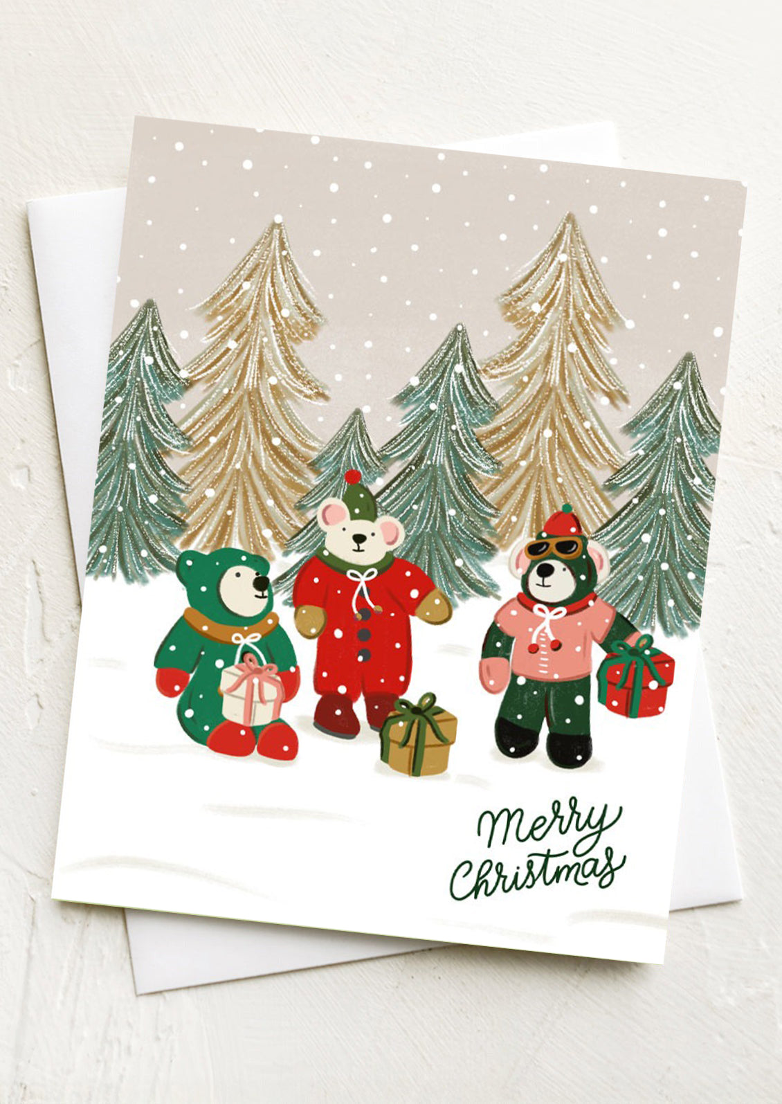 Christmas card with three bears in a forest scene and 'Merry Christmas' text.