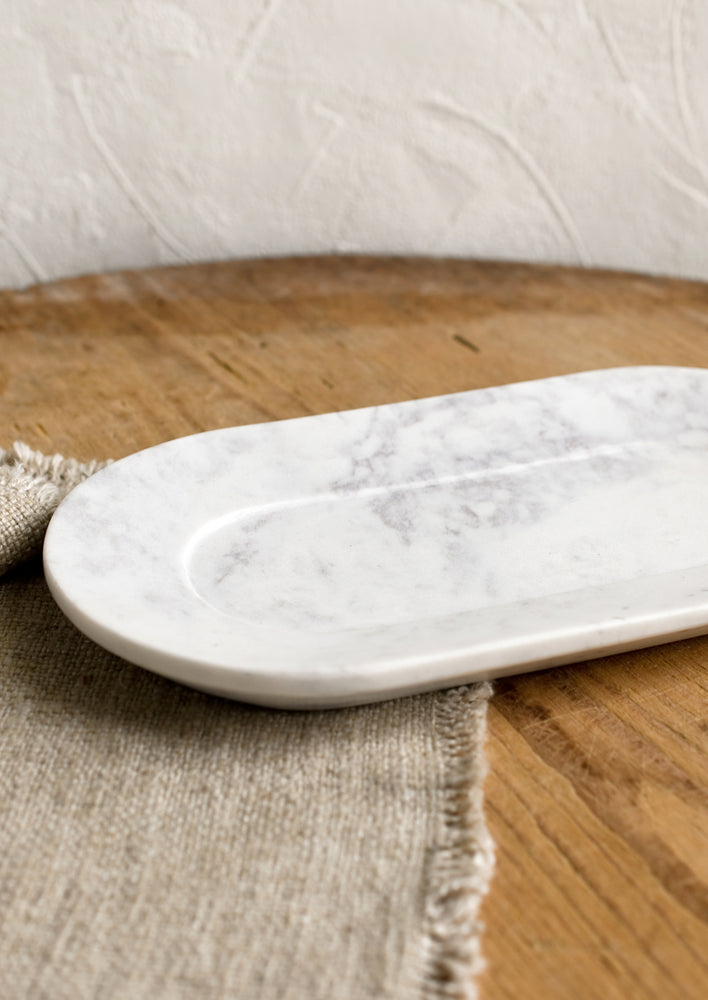 An oval shaped marble catchall tray.