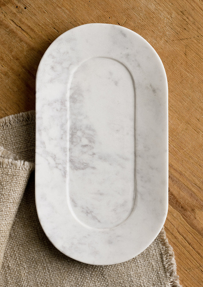 1: An oval shaped marble catchall tray.