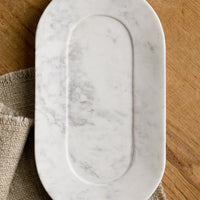 1: An oval shaped marble catchall tray.