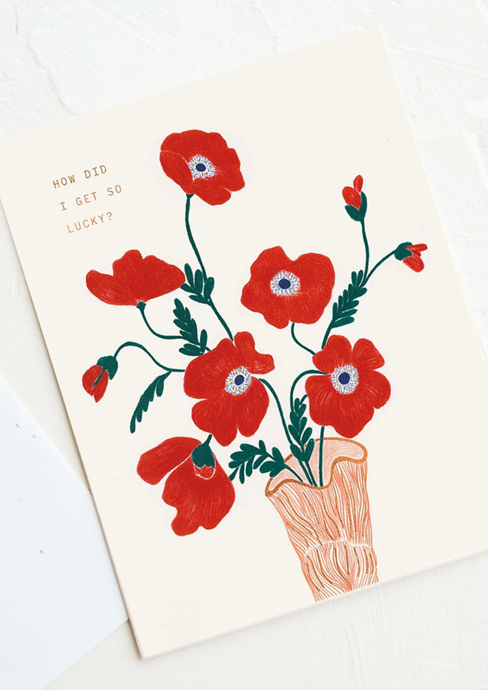 A card with red floral illustration, text reads "How Did I Get So Lucky?"