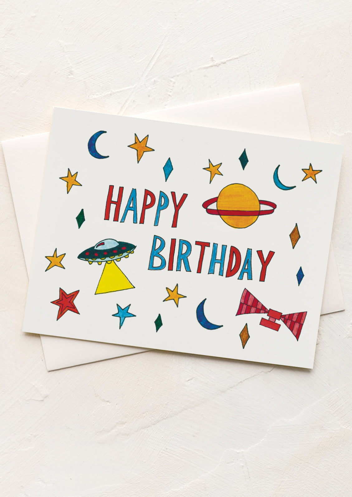 A birthday card with playful space drawings.