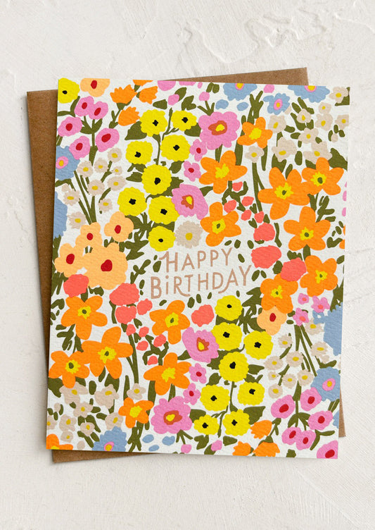 Floral birthday card with colorful flowers and 'Happy Birthday' text on a white background.