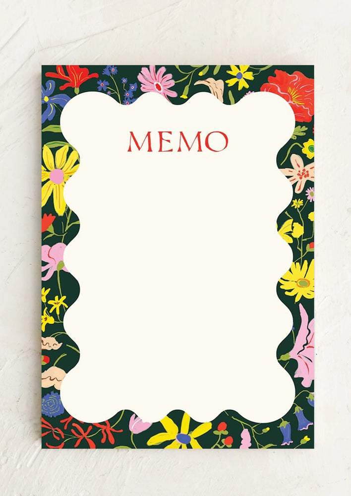 A floral patterned notepad with squiggle shape writing area.