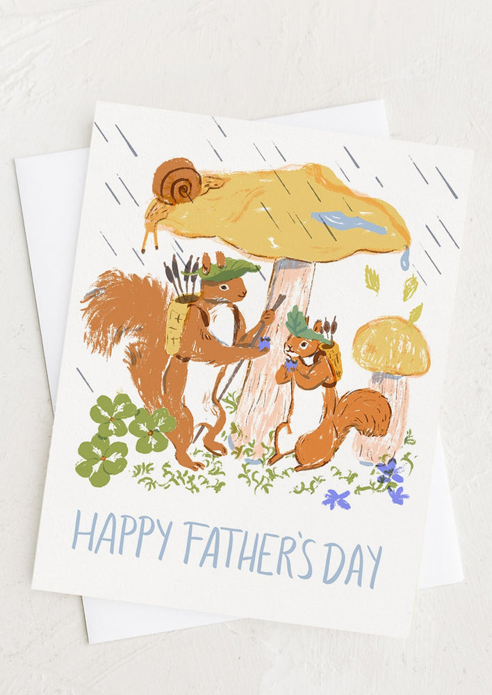A greeting card with illustration of two squirrels reading "Happy Father's Day".