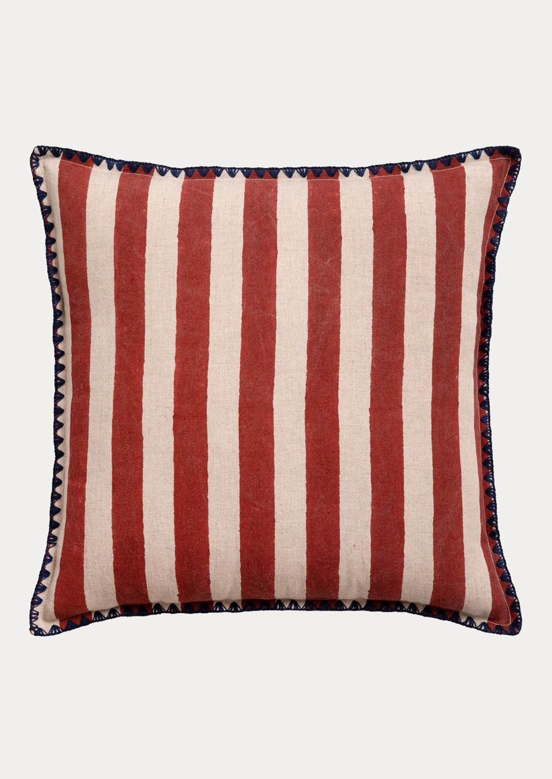 A square throw pillow with vertical red and cream stripes, finished with a dark navy blue and cream geometric patterned border.