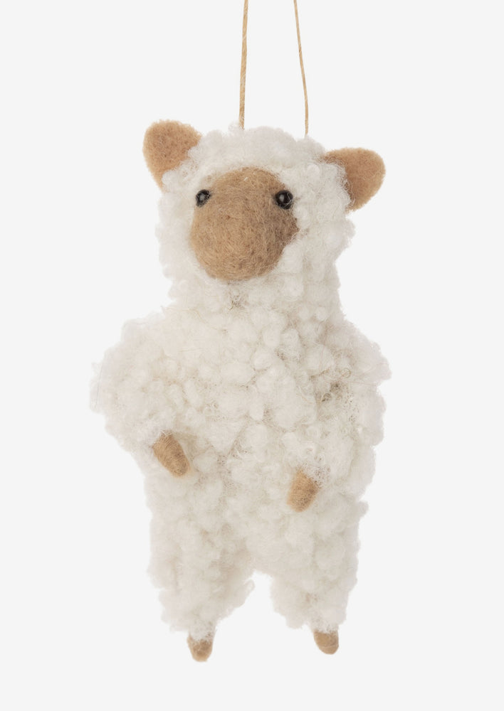 A felted mouse ornament wearing white sheep costume.