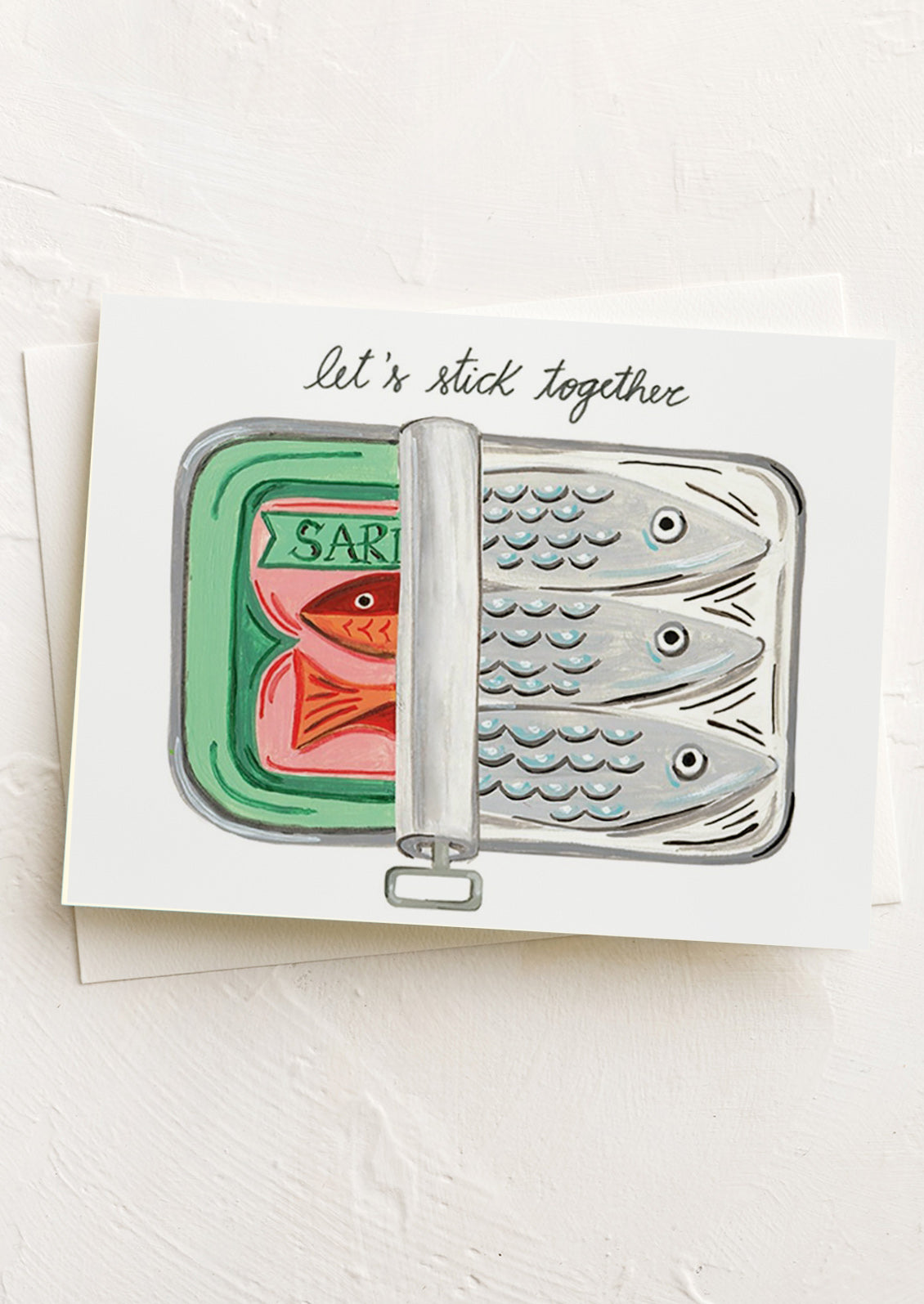 Card with a sardine can design featuring fish and text 'Let's stick together' on a white background.