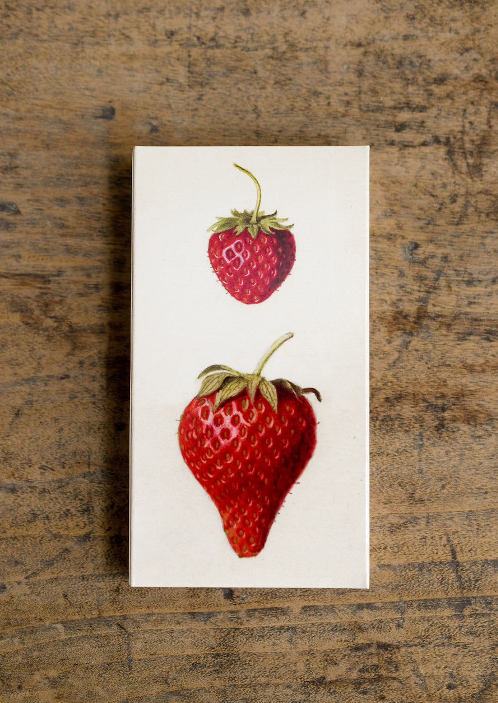 2: A box of long red tipped matches, box has vintage-inspired strawberry illustration.