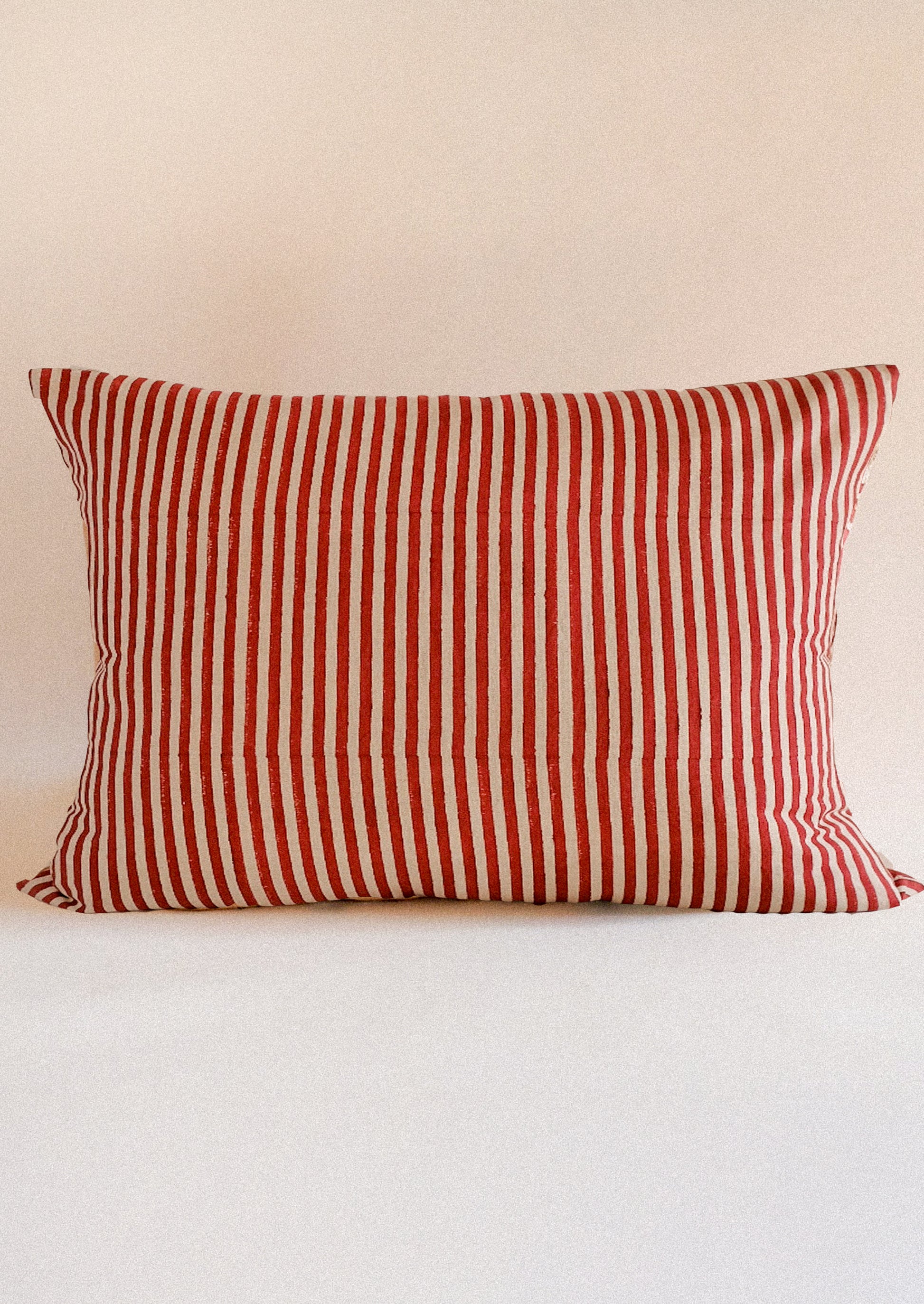 A lumbar throw pillow in red stripe.