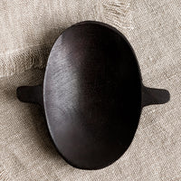 Small: A carved wooden dish with oval shape and little side tabs.