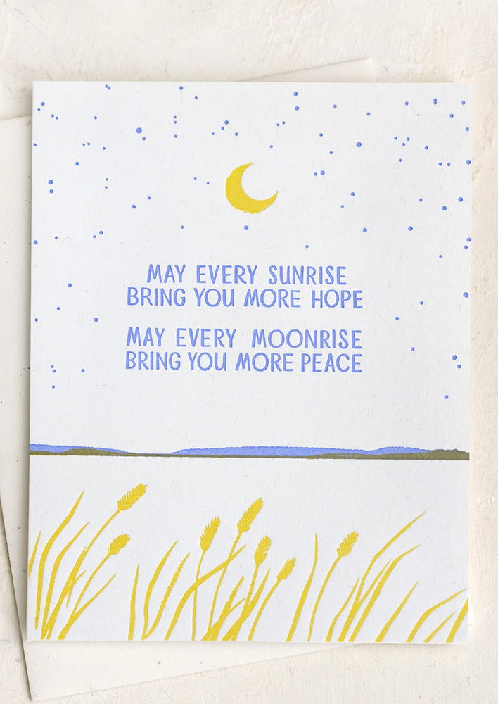 A card reading "May every sunrise bring you more hope, may every moonrise bring you more peace".