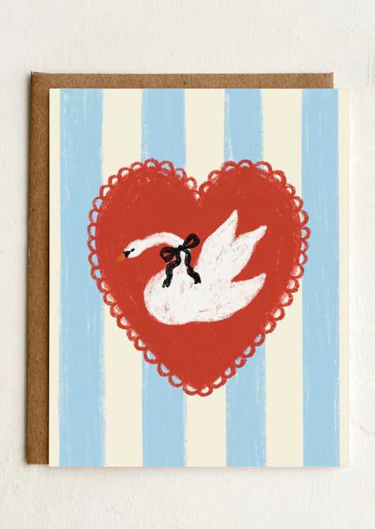 A blue and white striped greeting card with heart at center with illustration of swan.
