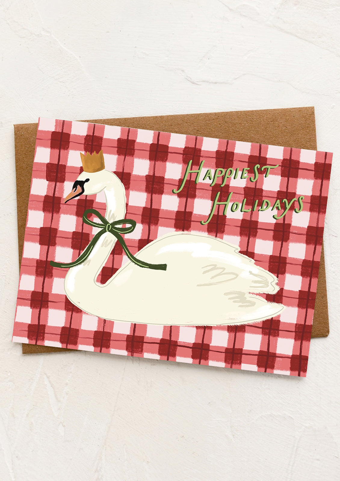Holiday card with swan illustration and 'Happiest Holidays' text on a red and white checkered background.