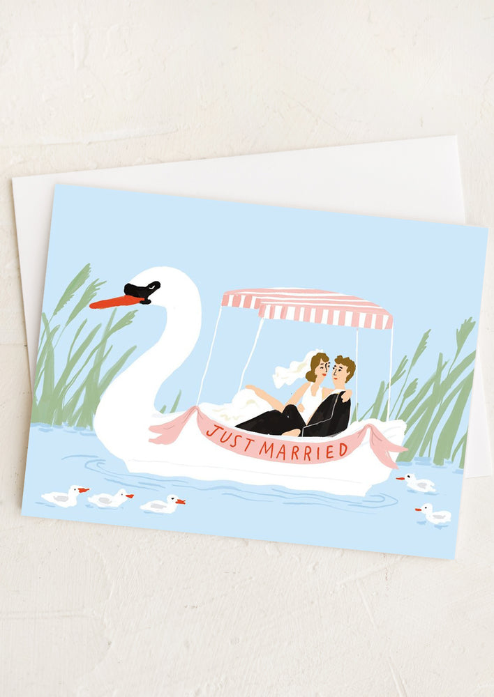 1: A greeting card with illustration of man and woman in swan wedding boat.
