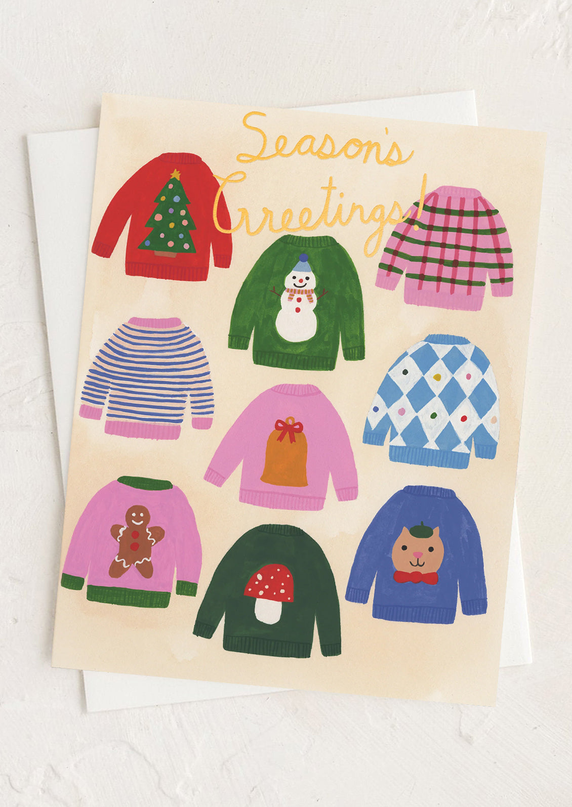 A greeting card with illustration of Christmas festive sweaters, text reads "Season's Greetings!".