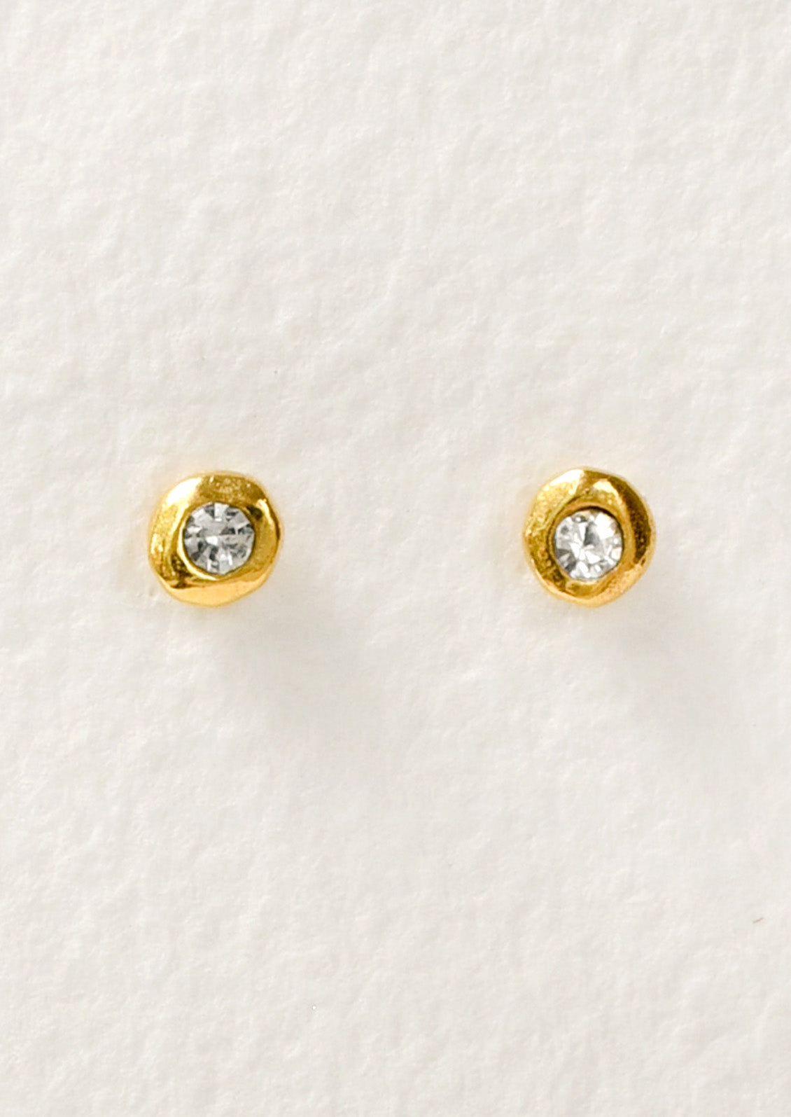 A pair of gold stud earrings with a crystal center.