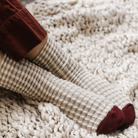 3: A pair of socks in cream gingham with burgundy cap toe.