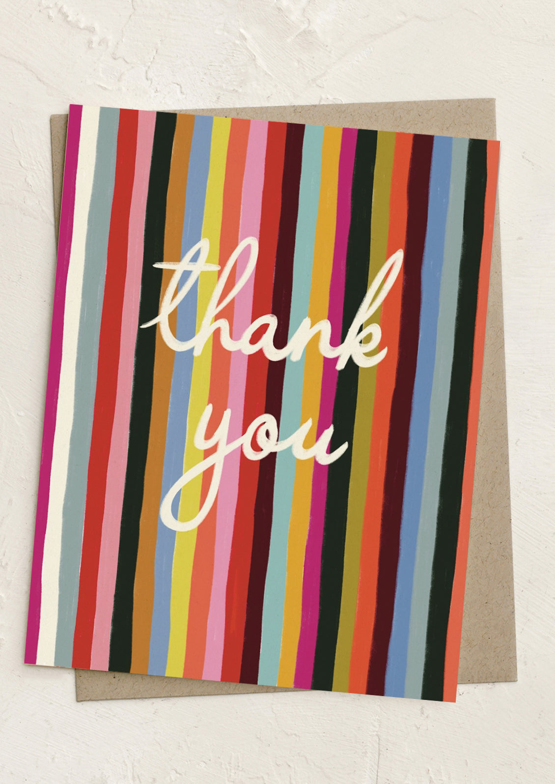 A rainbow striped greeting card reading "Thank you".
