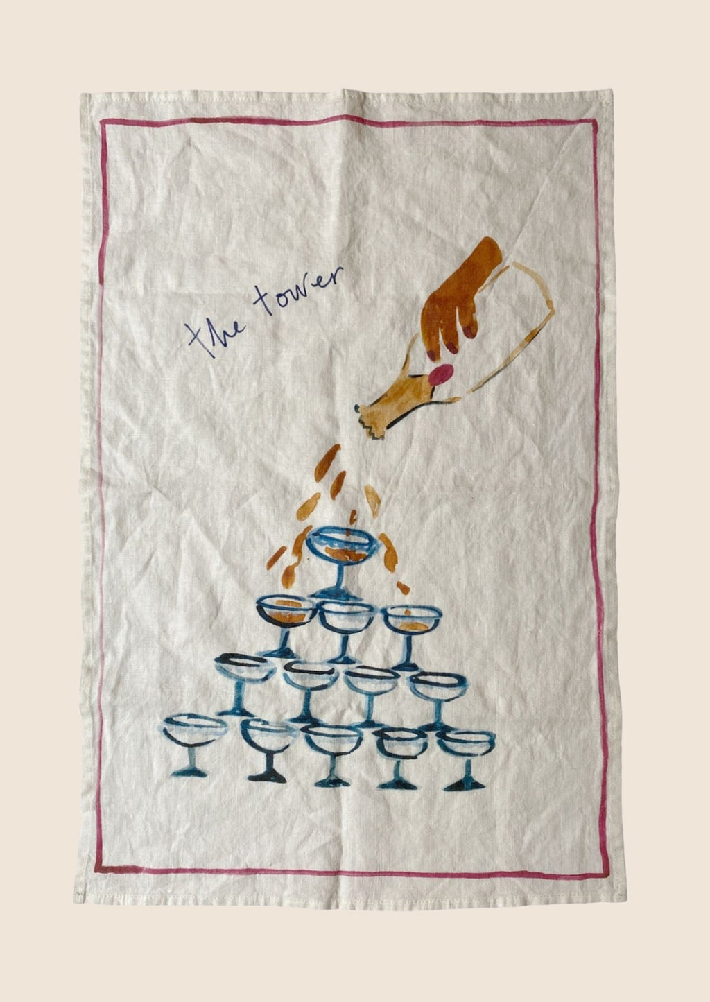 The Tower: A white linen tea towel with martini tower graphic and text.