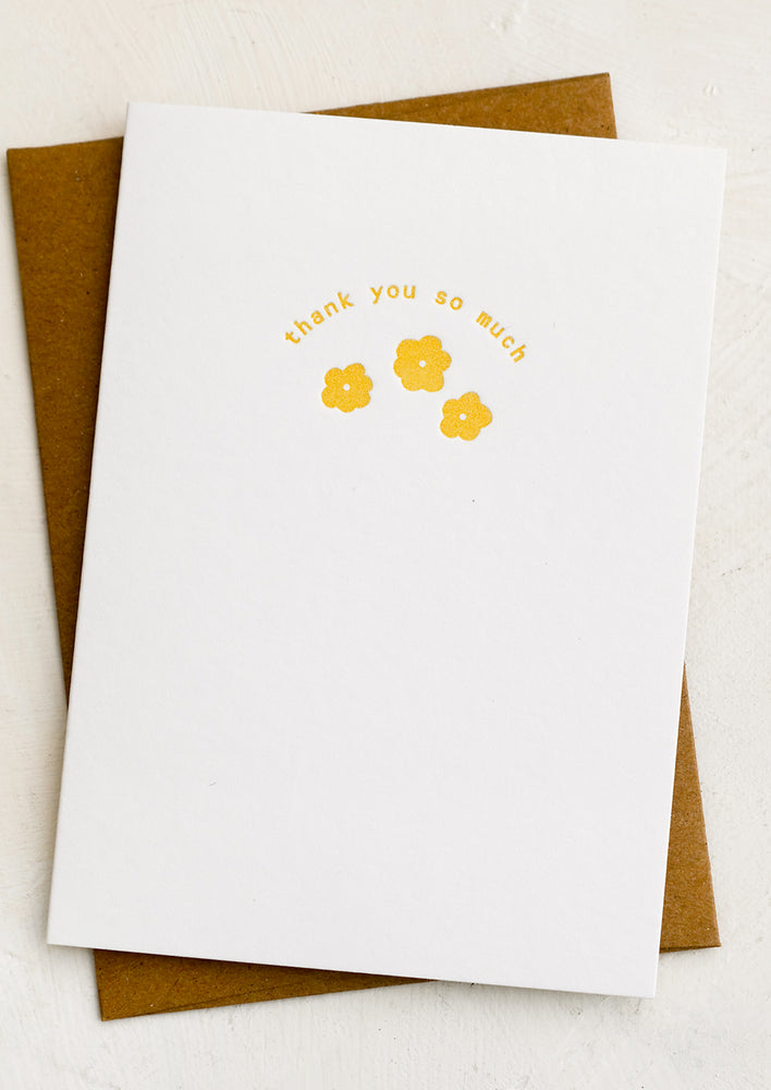 1: A greeting card with yellow small flower design and text.