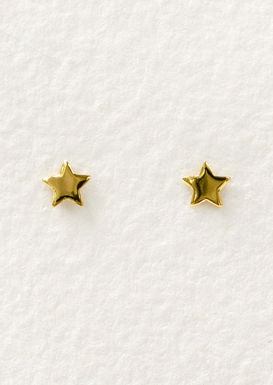 A pair of tiny gold star studs.