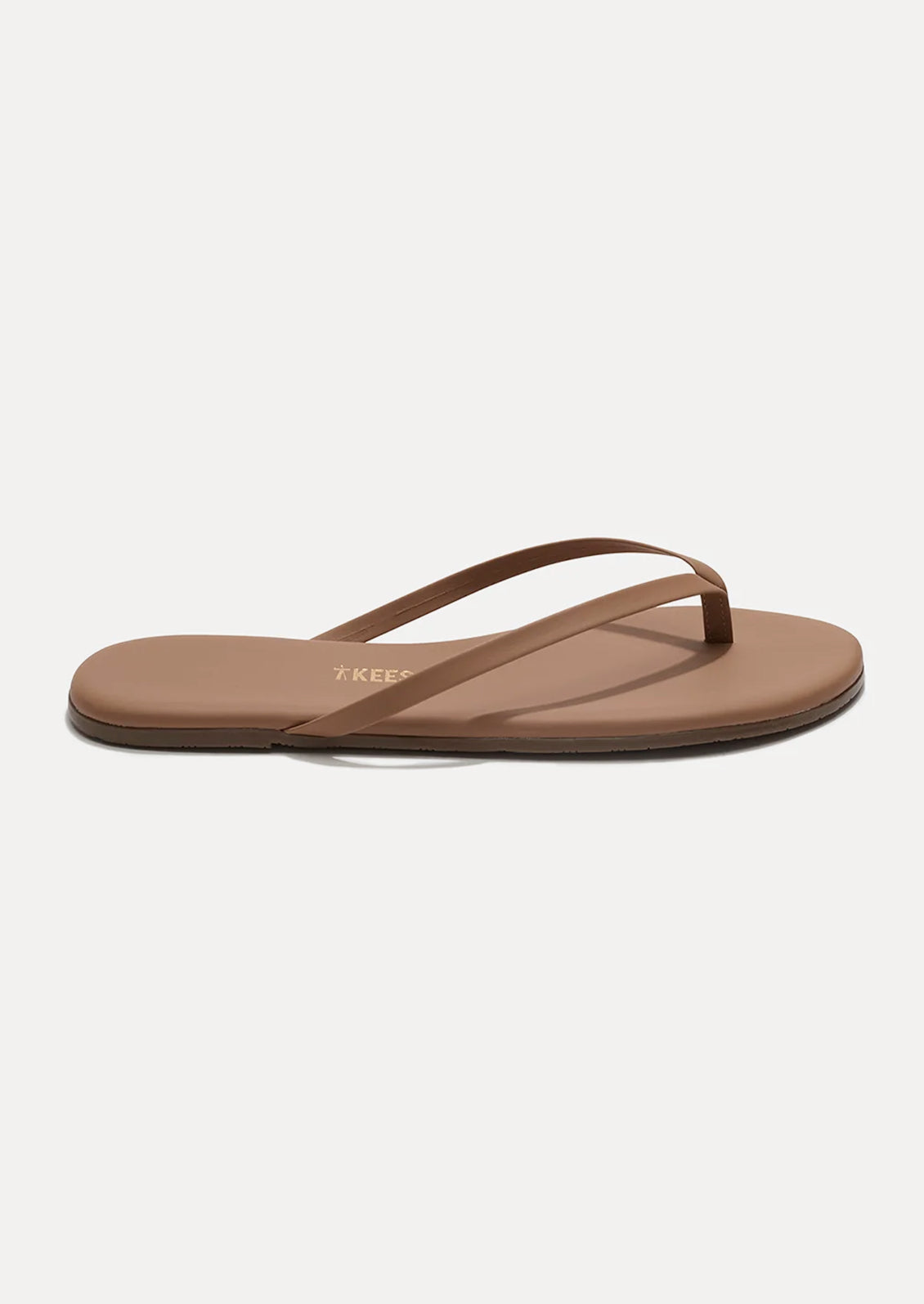 A leather skinny strap TKEES sandal in nude.