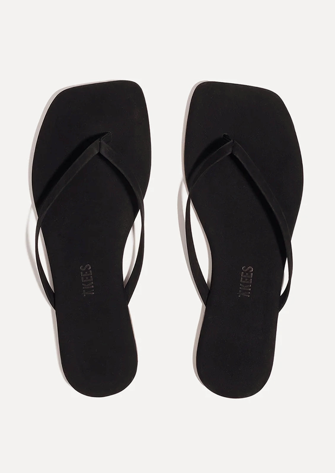 A pair of suede square toe TKEES sandals in black.