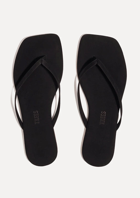A pair of suede square toe TKEES sandals in black.