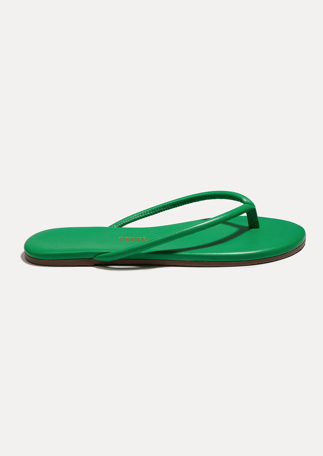 A leather TKEES sandal with a tubular strap design in kelly green.